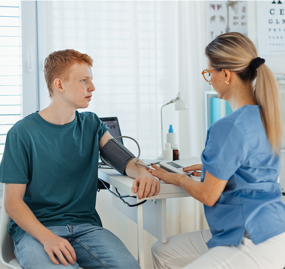 Patient getting blood pressure checked by nurse.