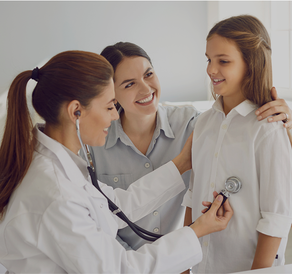 Doctor examining girl with a stethoscope.